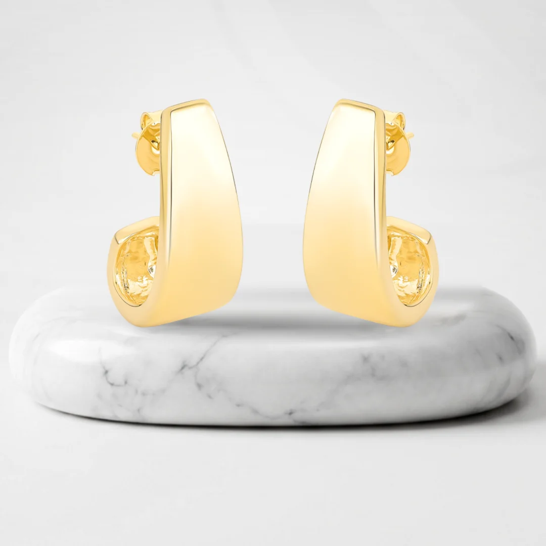 Pair of earrings with Bari gold plating on a marble pedestal