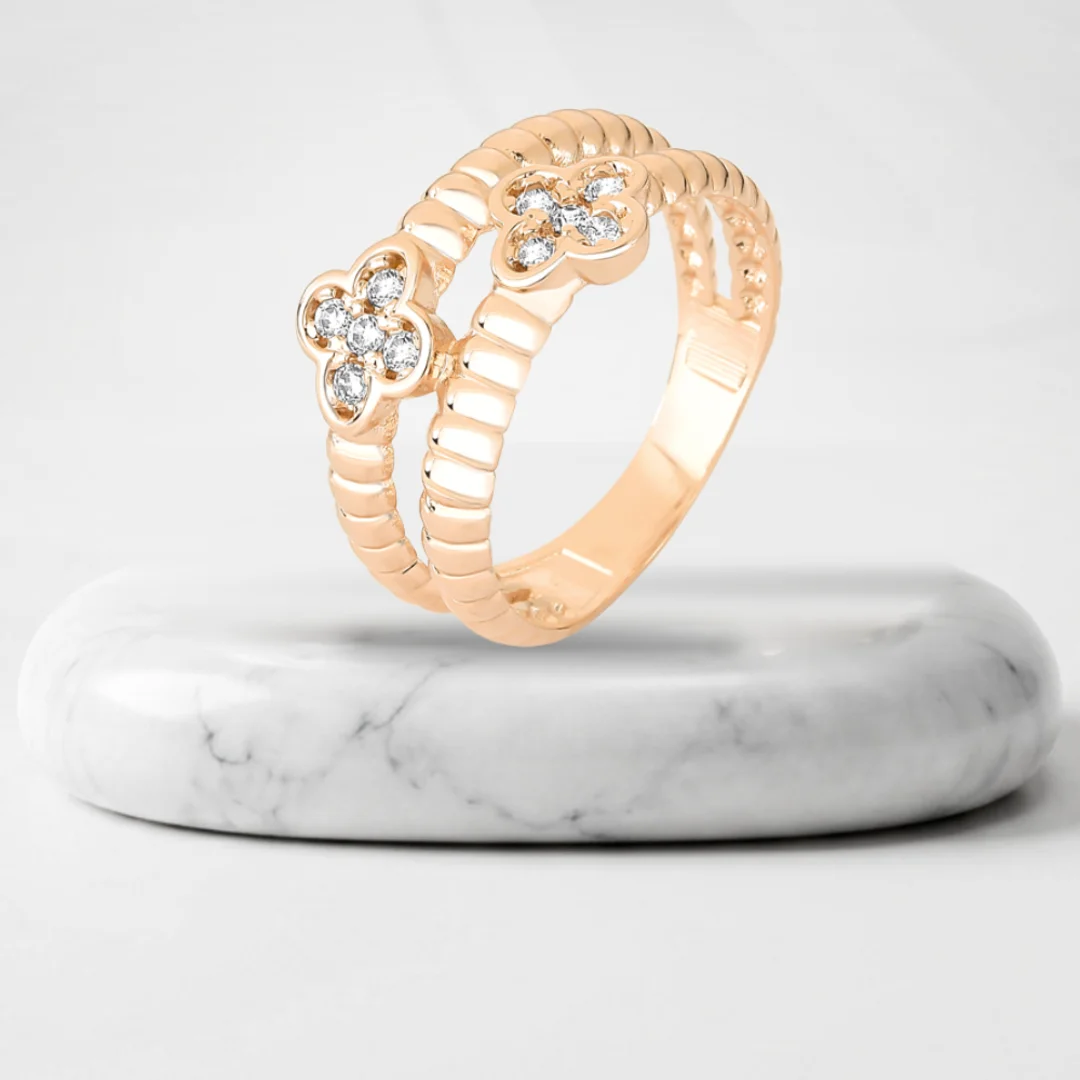 Ring with zirconia flowers with Vienna gold plating on a marble pedestal